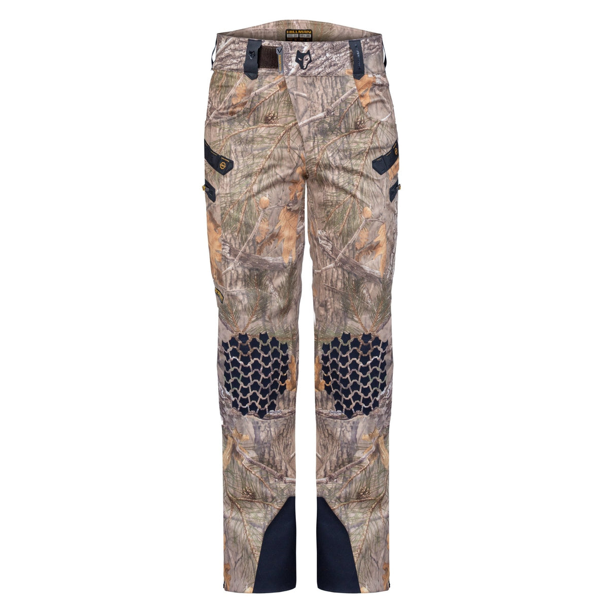A product image on a white background: Hillman Cold Weather Camo Pants featuring reinforced black knee patches, black pocket accents, and durable ankle material. These insulated pants are ideal for hunters needing reliable camo gear.