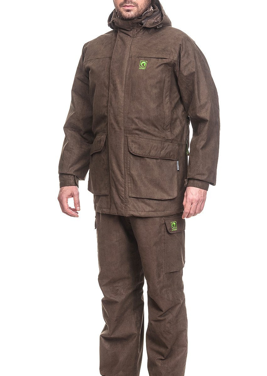 Three-quarter view of a man dressed in a dark brown winter hunting suit, highlighting the heavy-duty weather-resistant jacket, attached protective hood, and matching cargo pants with bright green Argo logos.