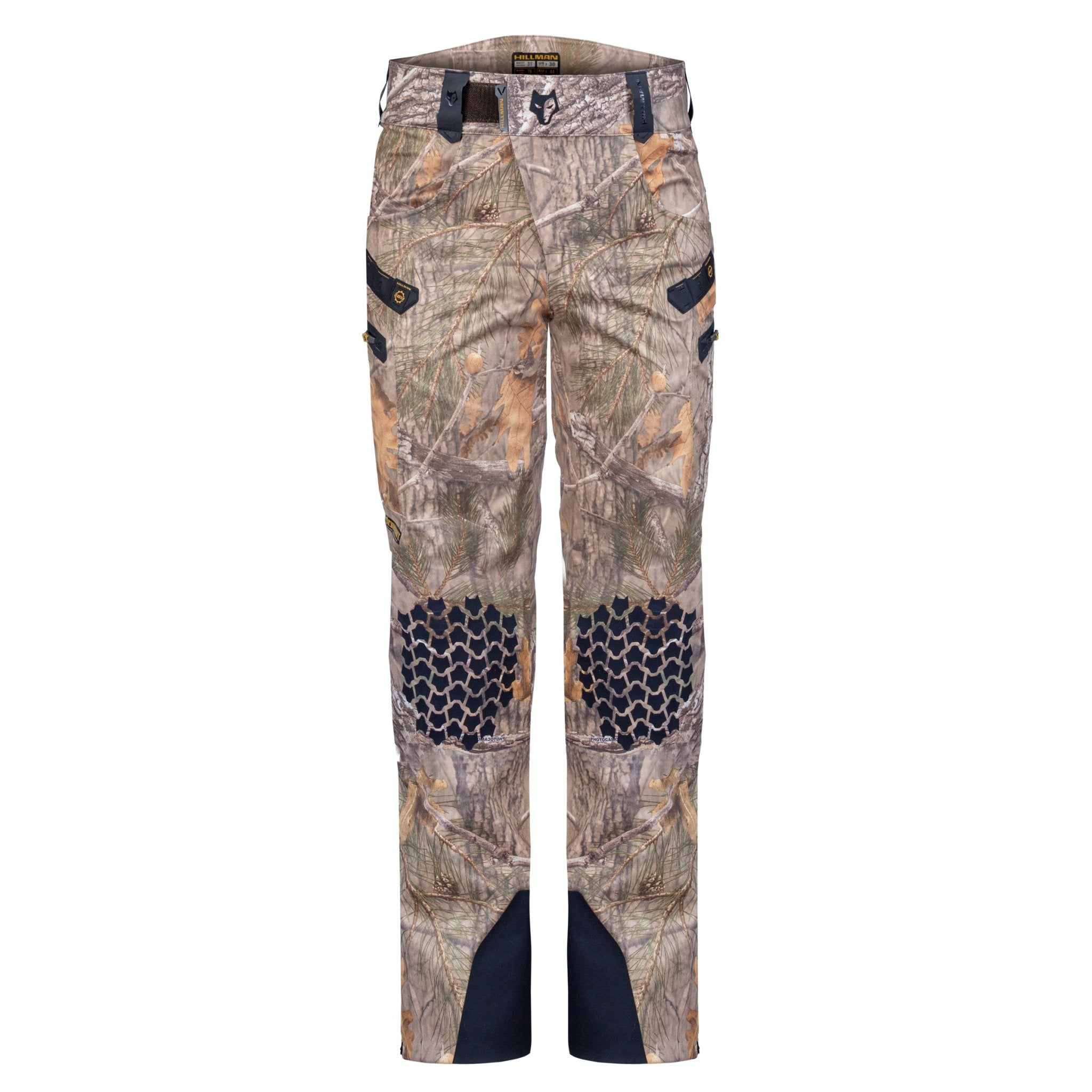 Hillman Cold Weather Camo Pants - Winter Hunting AlphaShell | 6OL feature reinforced black knee patches, black pocket accents, and durable ankle material. Displayed on a white background, these insulated pants are ideal for hunters needing reliable camo gear.